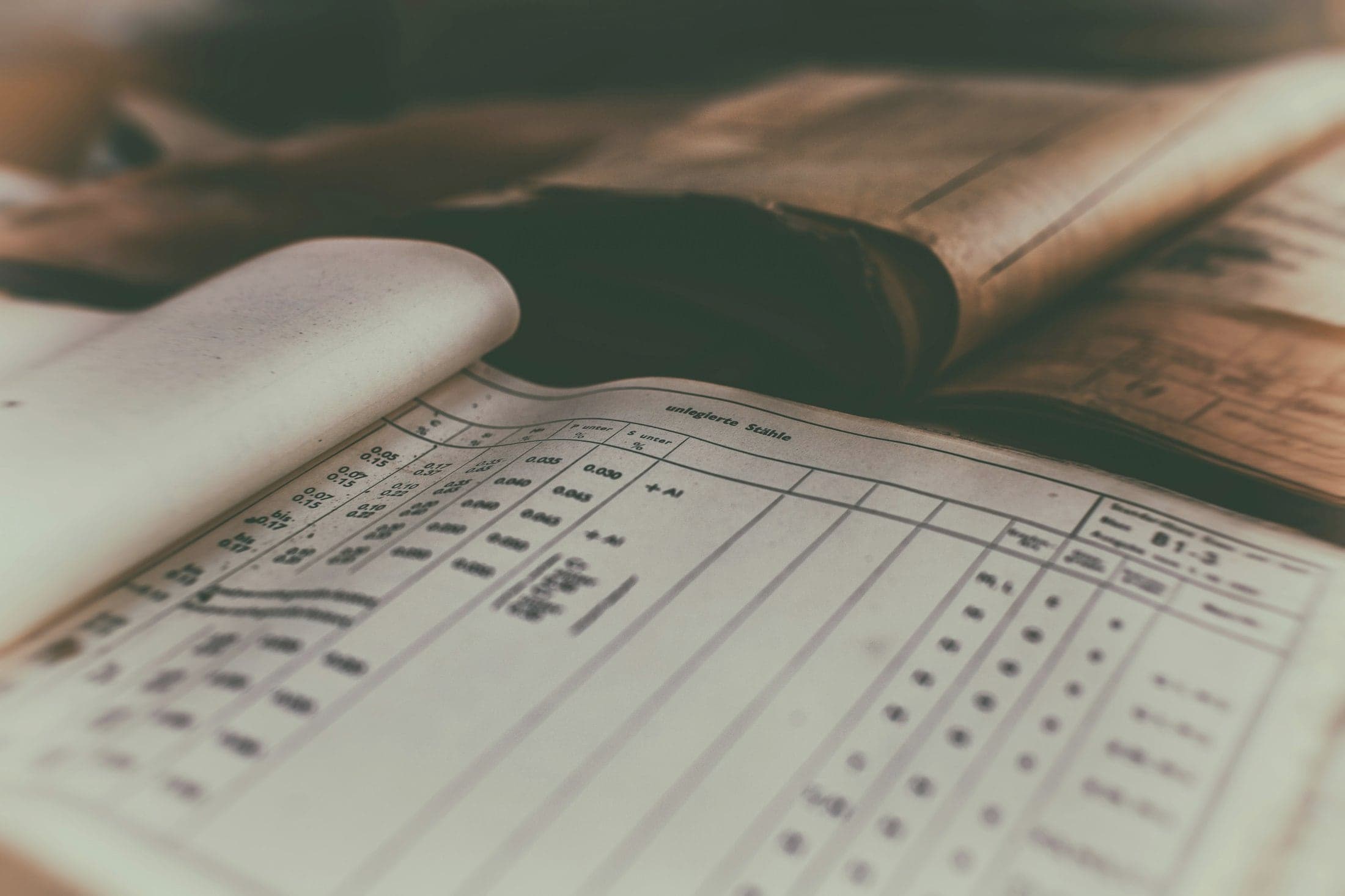 An old handwritten ledger lying open, its columns filled with careful figures